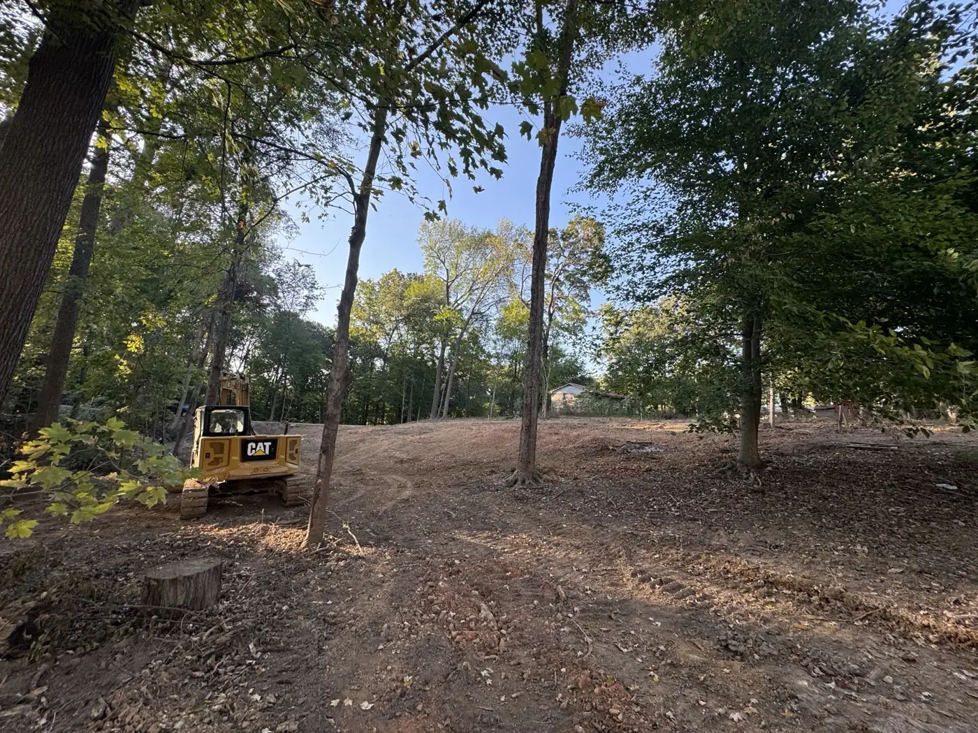 Tracked excavator parked on freshly cleared and graded ground