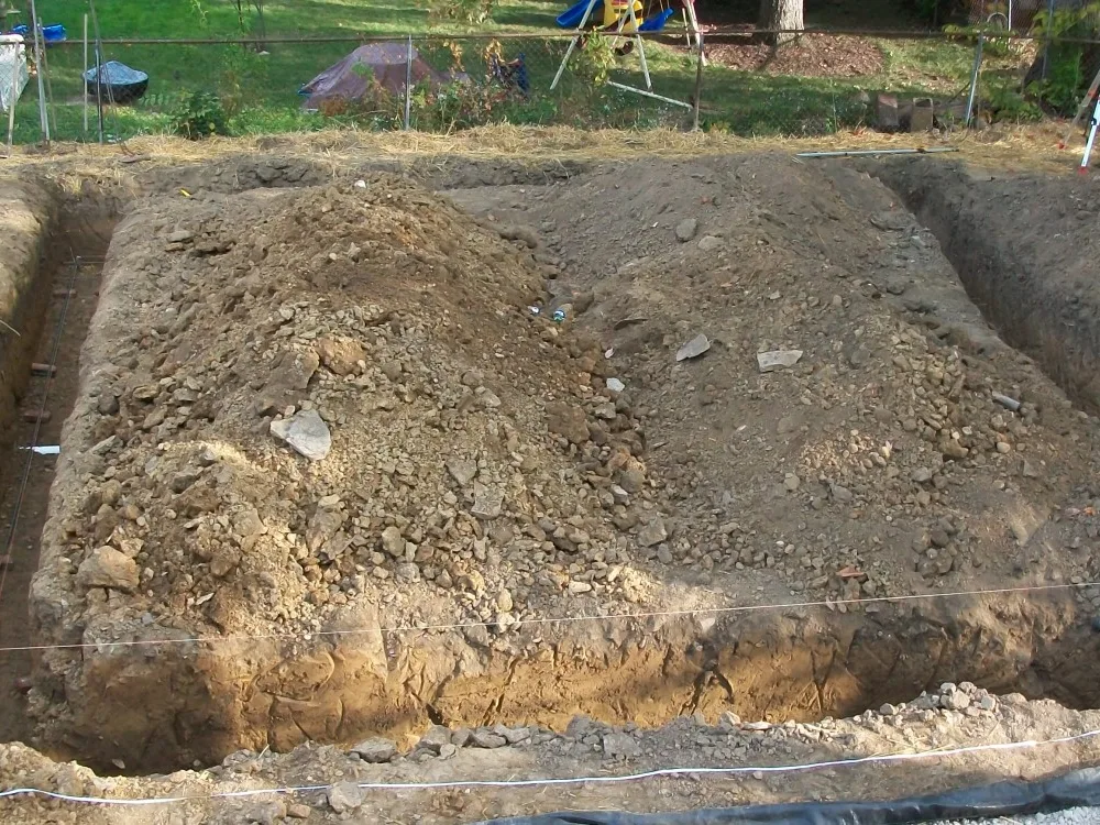 Footer trenches dug for a house foundation with string lines set along them