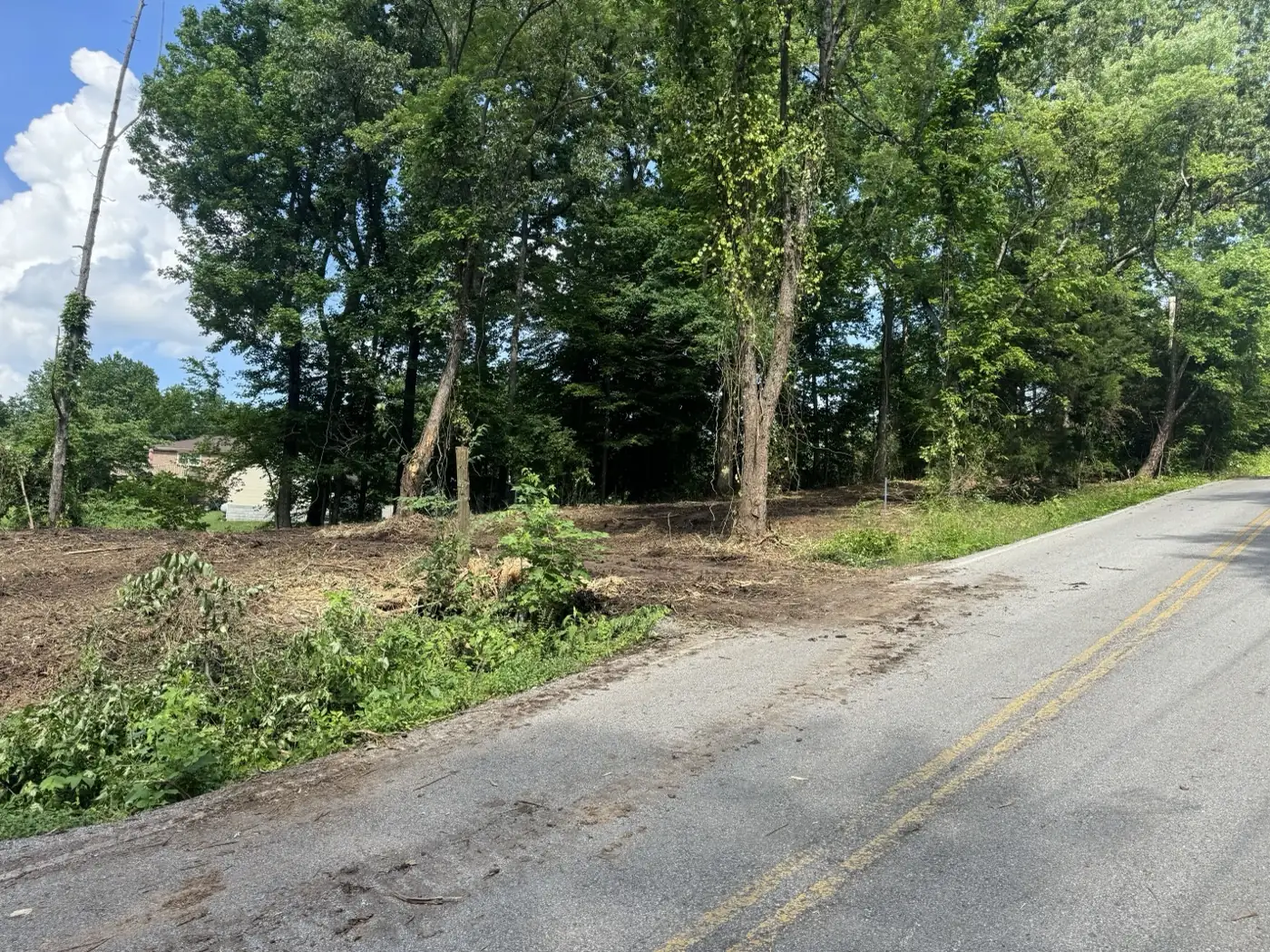 Cleared roadside lot with the brush gone and bare ground opened up